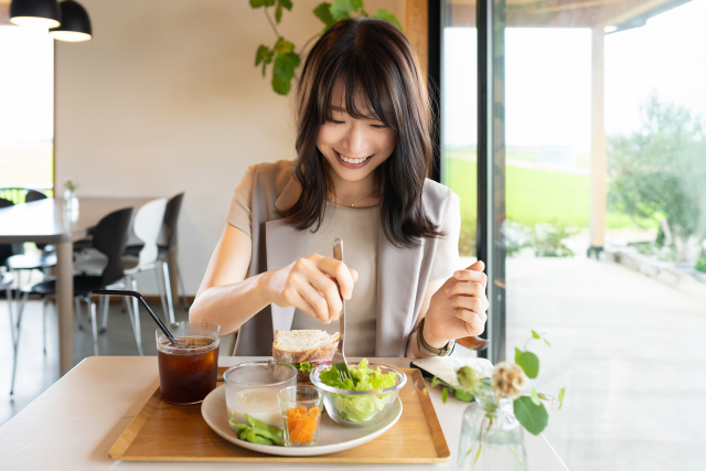 自分らしい選択をする女性が、カフェでランチを選んでいる様子。 日常の中の小さな決断が、自己肯定感を育てることを表現したイメージ。